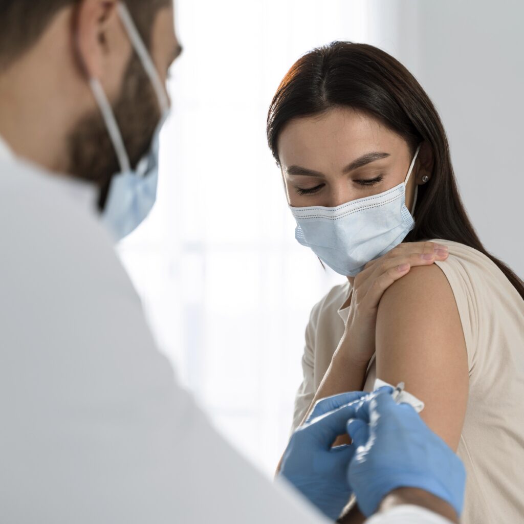 doctor doing vaccine to patient